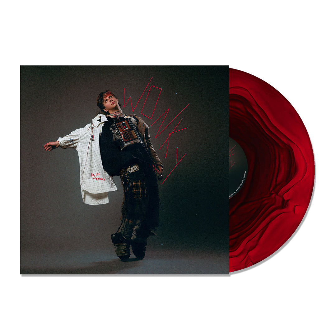 Album cover for Wonky showing a person in a Comfort Colors T-shirt leaning backward in layered clothing, with a red swirling limited edition vinyl record partially pulled out of the sleeve.