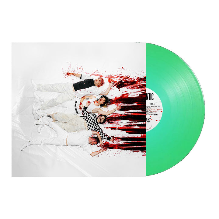 Five people in white clothing lie on a white floor with red paint splatters, recreating Stand Atlantics GIRL$ [feat. PVRIS &amp; Bruses] green vinyl cover art. The bold, vibrant image is full of artistic energy.