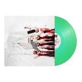 Five people in white clothing lie on a white floor with red paint splatters, recreating Stand Atlantics GIRL$ [feat. PVRIS & Bruses] green vinyl cover art. The bold, vibrant image is full of artistic energy.