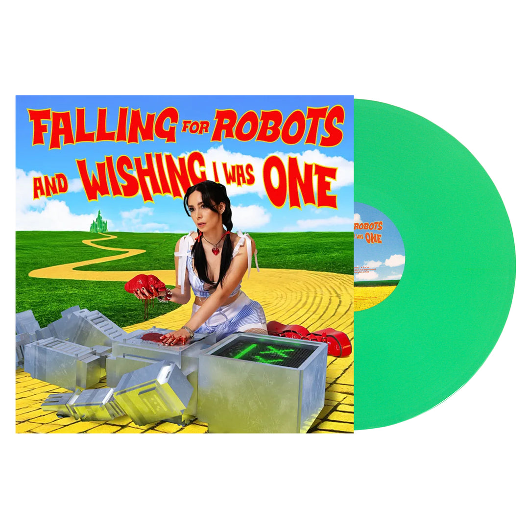 The L0L0 album cover for Falling for Robots and Wishing I Was One features a woman in a Dorothy costume repairing a robot on a yellow brick road, with a green vinyl visible—hot girls in hell vibes, but with sparks and heart.