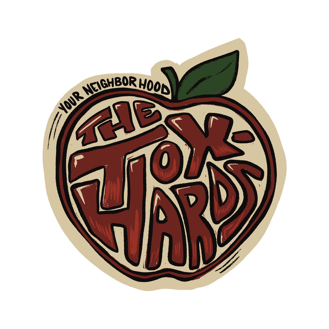 A stylized, scented illustration of an apple with a green leaf, featuring the words THE TOXHARDS in bold, playful lettering.