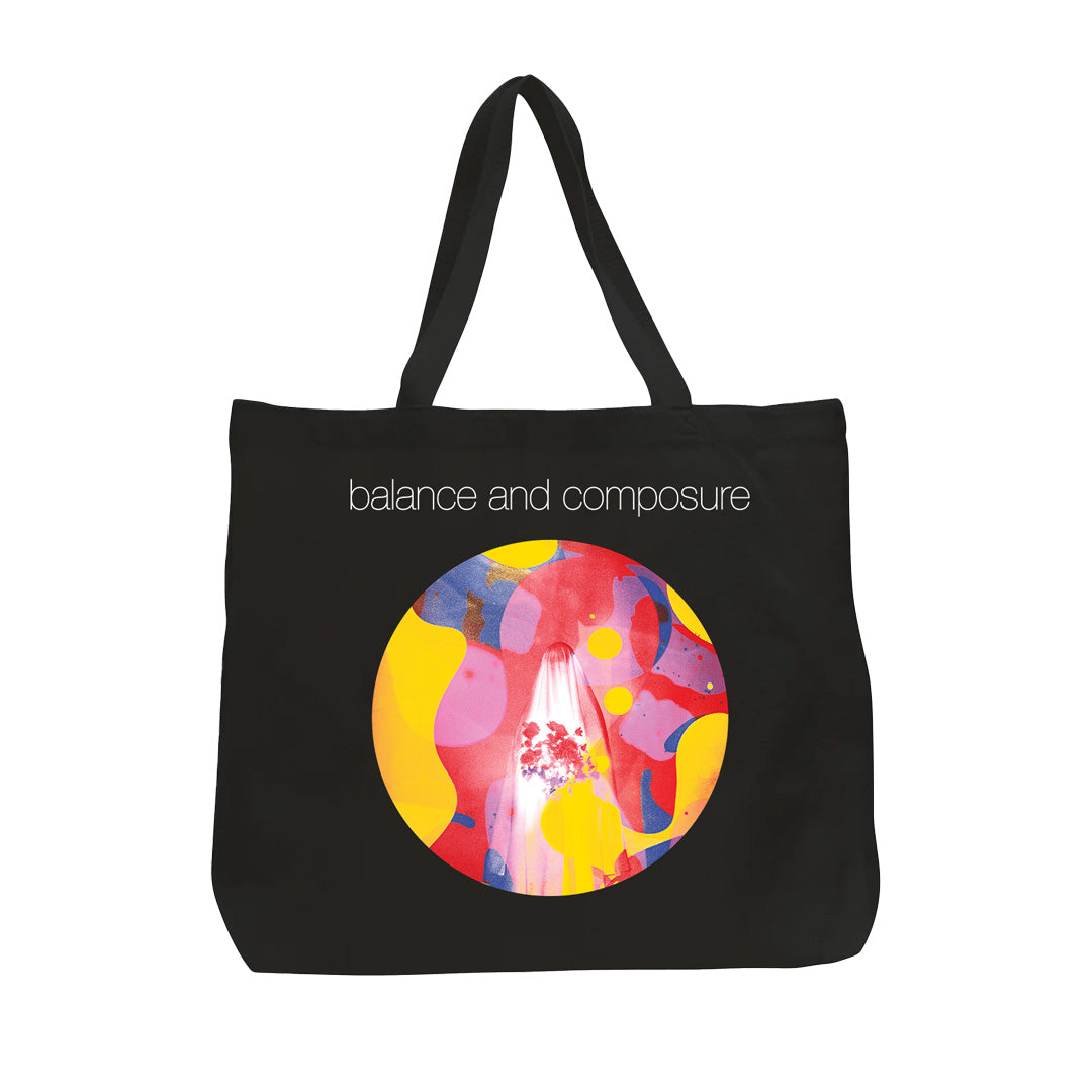A jumbo tote bag by Balance And Composure featuring their name above a circular abstract design in red, yellow, blue, and pink.