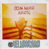 A sunlit photo shows a coin-operated binocular viewer on a boardwalk with Yellowcard’s name featured in bold. The warm, vintage filter creates an inviting Acoustic Album vibe.