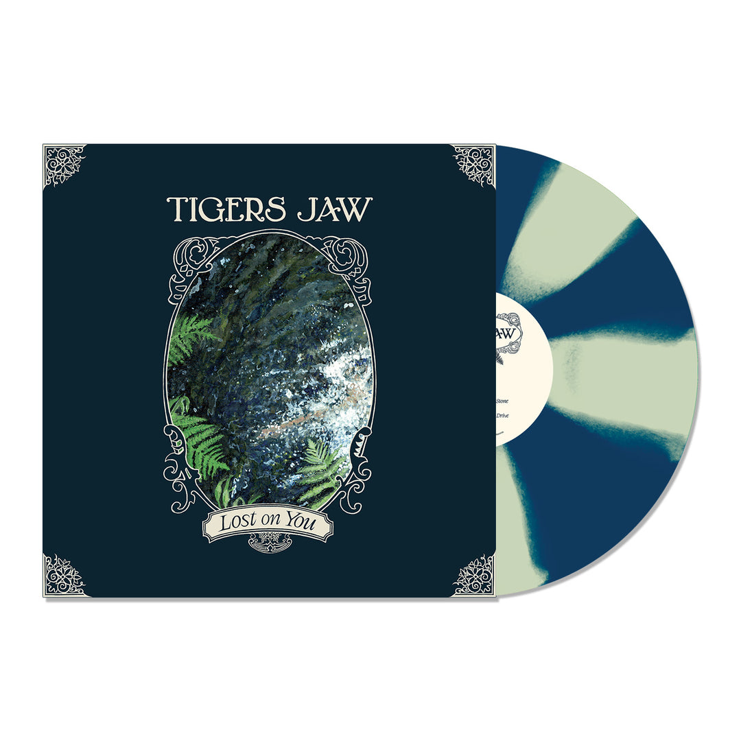 A dark blue Blue Cornetto LP with light green streaks by Tigers Jaw, titled "Lost on You," is partially out of its illustrated forest sleeve and shown on a white background.