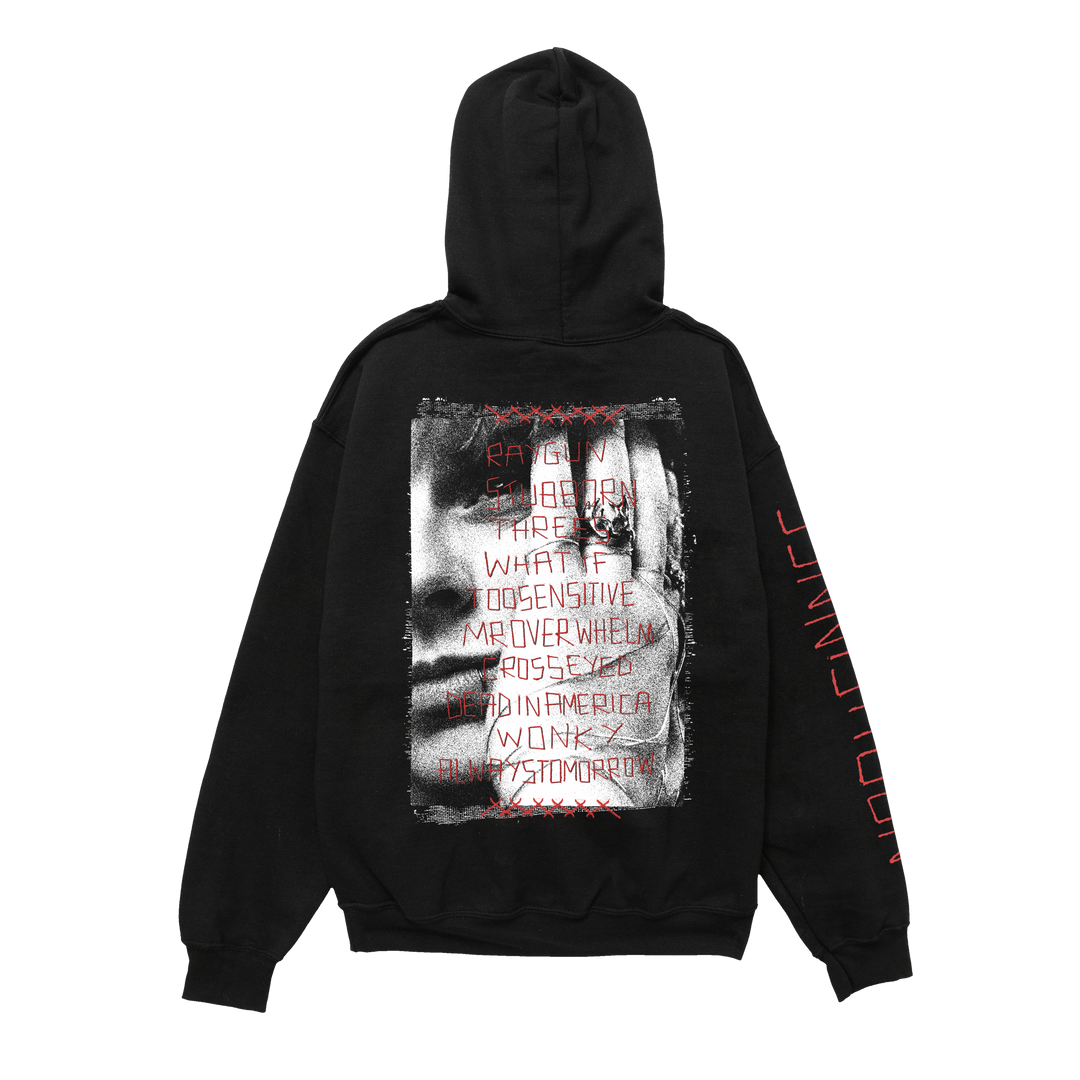 Black Independent Trading Co. hoodie featuring a back graphic of a face overlaid with red stitched text reading RAYGUN, STUBBORN, and other tracklisting words, with vertical red text on the sleeve.