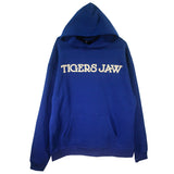 This limited edition royal blue TIGERS JAW hoodie by Tigers Jaw features large white felt applique lettering, a front pocket, and long sleeves.