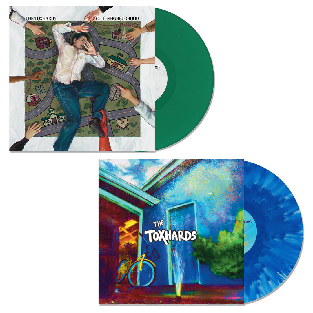 Two vinyl LPs by The Toxhards: a Green edition with cover art of a figure on a play mat street, and a Cloudy Blue edition featuring a vibrant house exterior with a bicycle.