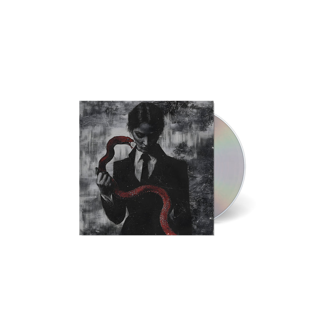 A CD case from TX2, featuring dark art of a suited figure holding a red snake on a textured grayscale background. The partially visible, reflective CD is perfect for fans of Ice Nine Kills or Johnny 3 Tears.