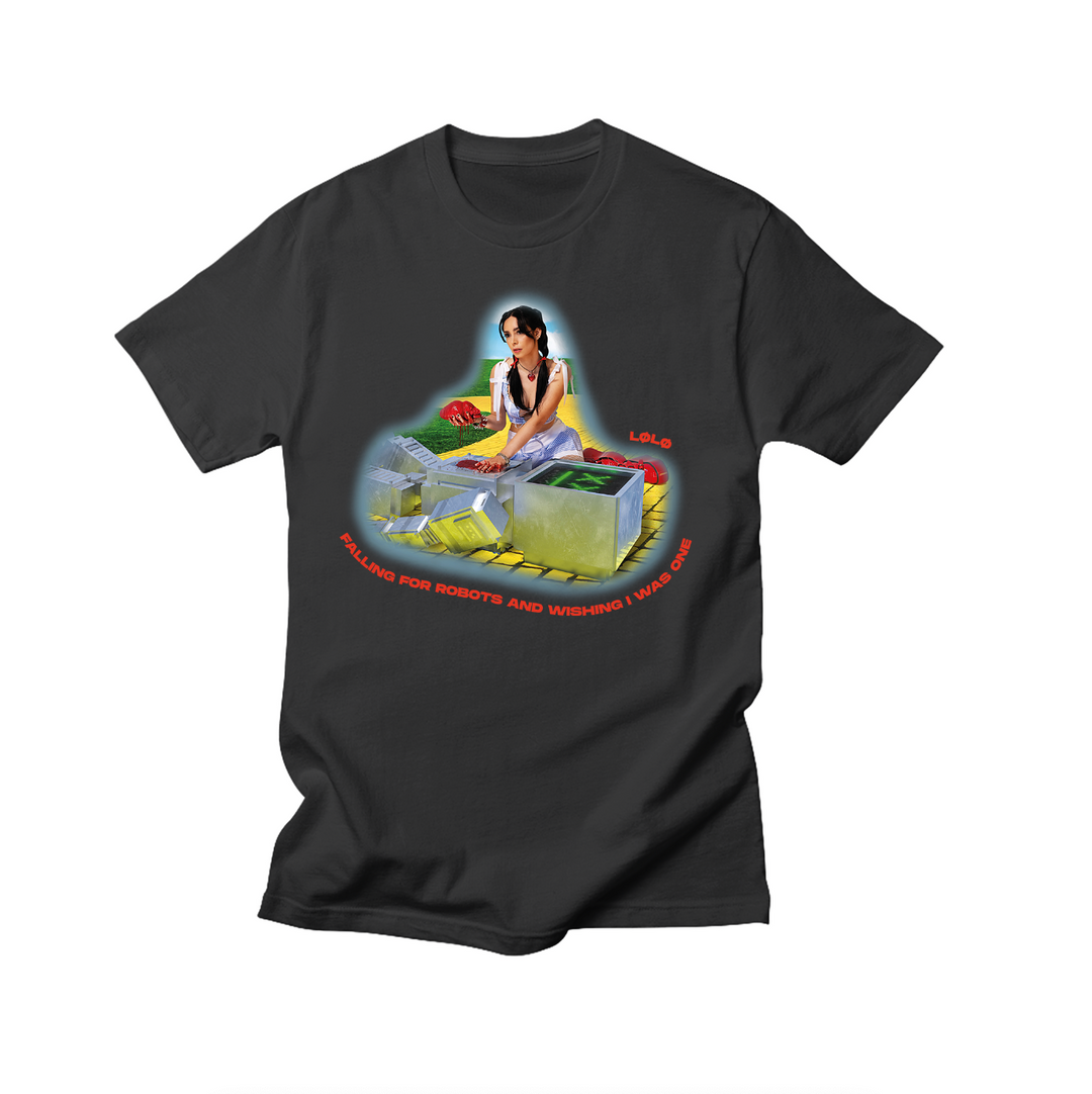 L0L0’s black, garment-dyed tee showcases an illustrated woman at a casino table with chips and cash, framed by neon lights. Below, it reads: SELLING FOR ROBOTS AND WISHING I HAD ONE. Stand out with this exclusive design.