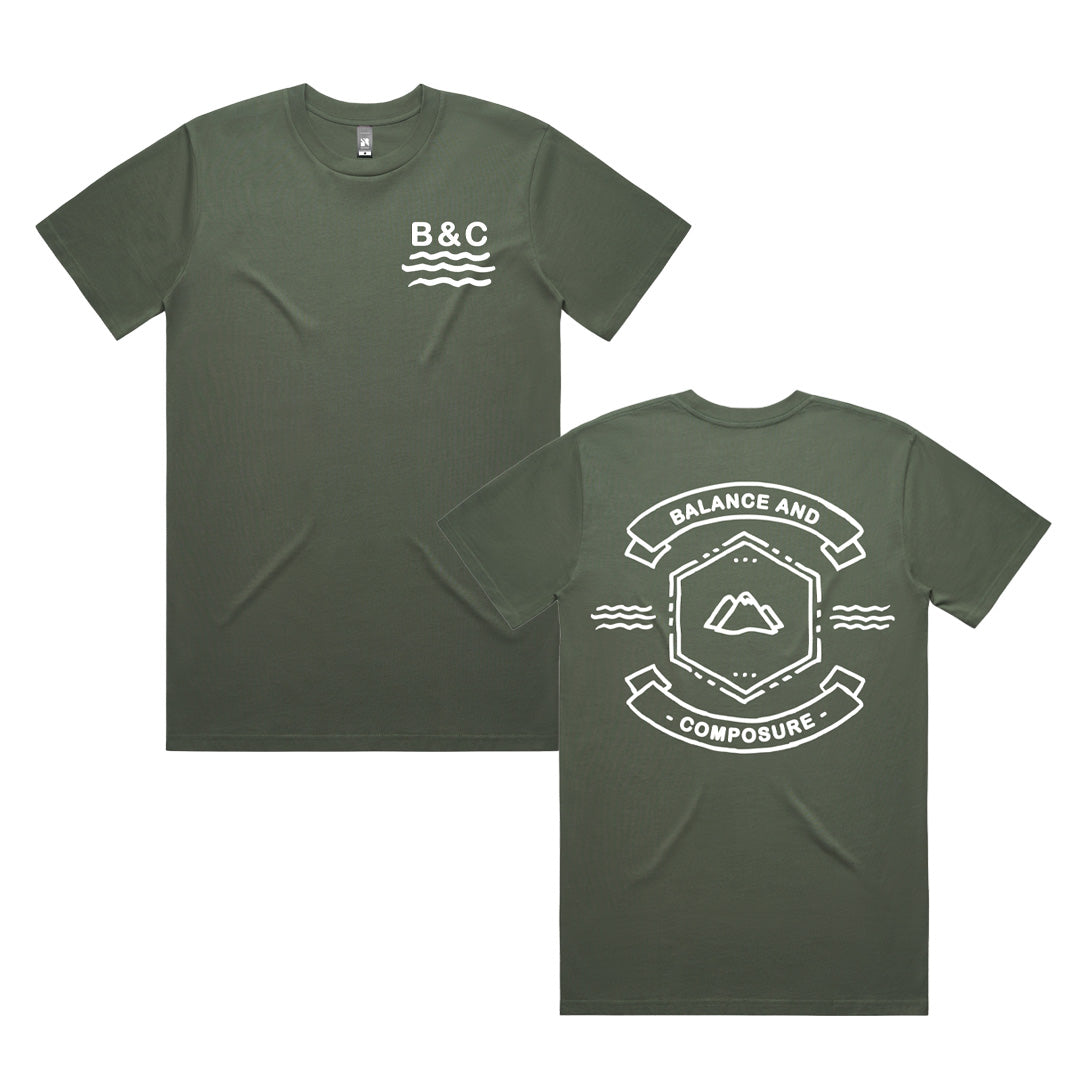Olive green Balance And Composure t-shirt with B&C and wave lines on the front left chest. The back features a geometric mountain and waves graphic, with Balance and Composure text above and below the design.