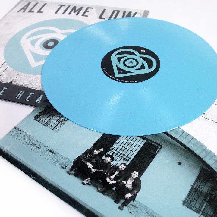 All Time Low "Future Hearts". Blue circle that contains a heart and eyeball. Showcase of Light Blue Vinyl