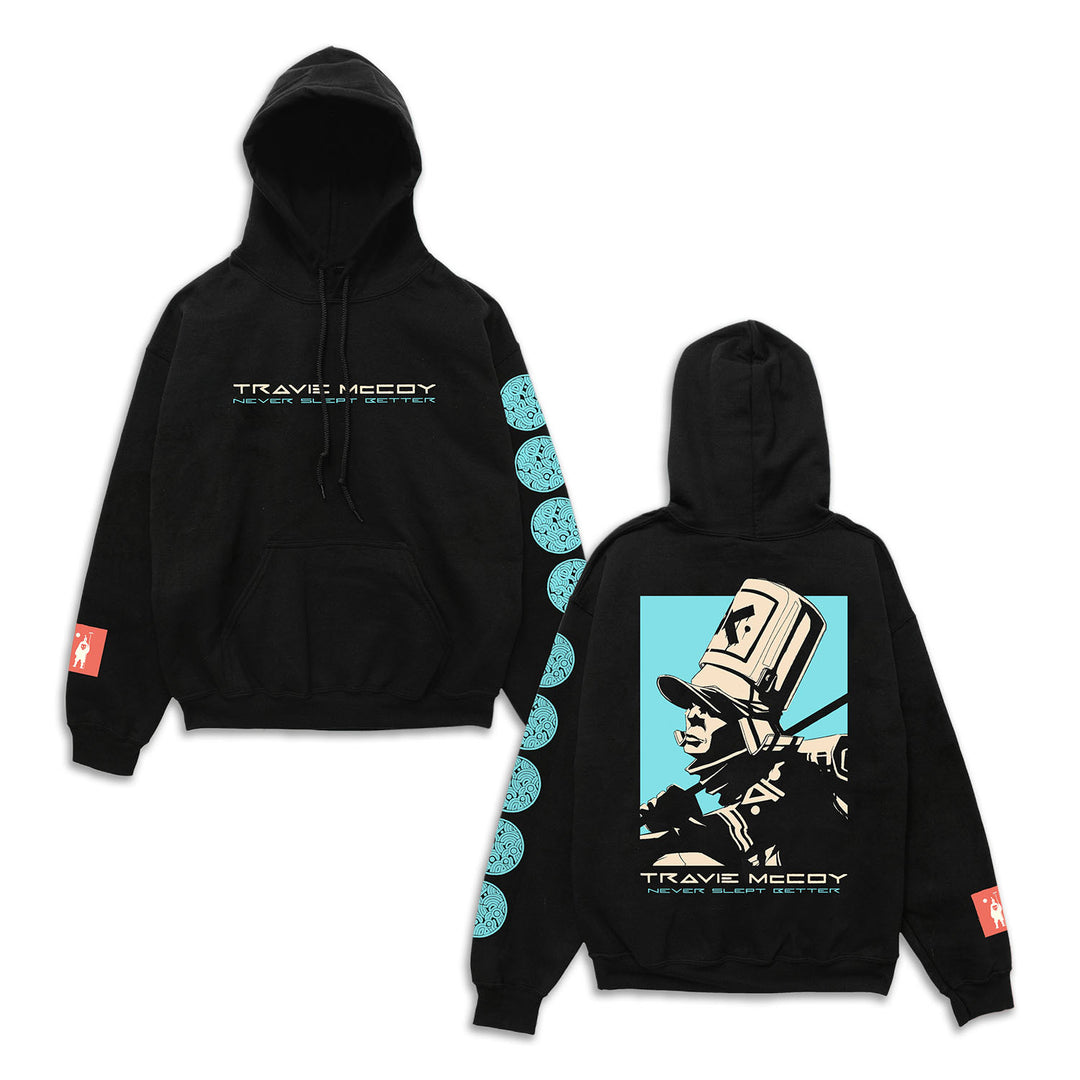Black Pullover Hoodie by Travie McCoy with text on front, blue circles down one sleeve, a red symbol on the cuff, and a bold back graphic of a top-hatted figure bordered in blue—Never Slept Better style.