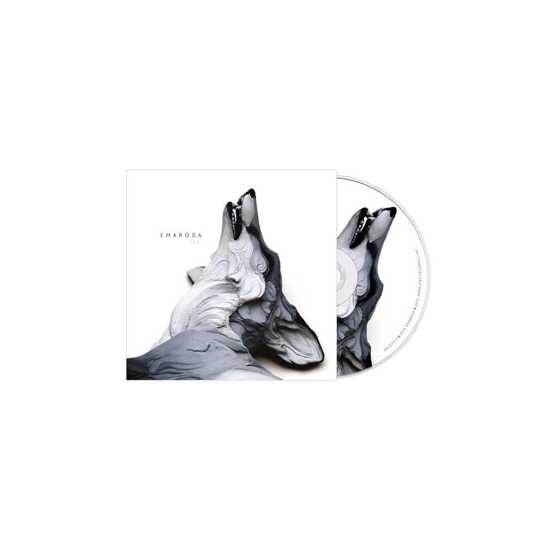 Emarosas 131 CD cover features abstract grayscale artwork of a howling wolf, symbolizing strength and hurt, on a minimalistic white background. The porcelain-like wolf design also appears on the CD. Brand: Emarosa.