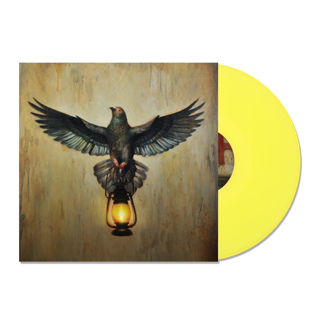 A yellow vinyl record slides from its cover, featuring a pigeon with wings spread on a lit lantern against an earthy backdrop—the perfect display piece for your Silverstein collection.