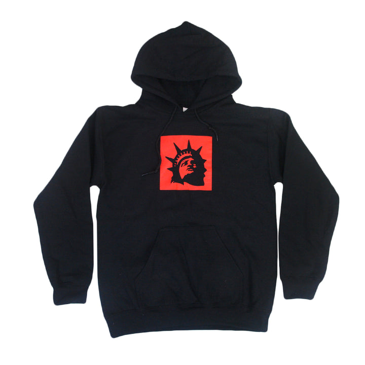 Trophy Eyes black hoodie with a front pocket, featuring a red square on the chest with a black Statue of Liberty head graphic—an iconic piece from the Liberty Square Black collection.