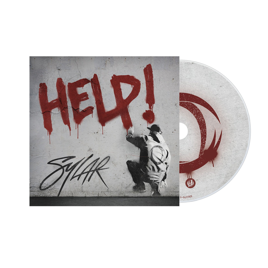 A Sylar CD and cover show a person spray-painting HELP! in red on a wall, with a bold Sylar signature below. The design’s raw emotion matches the Dark Daze theme, featuring a circular red motif on the CD’s white background.
