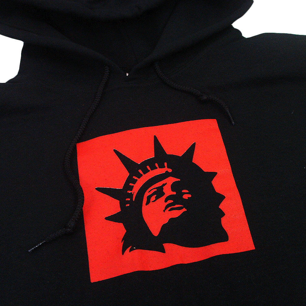A Trophy Eyes Liberty Square Black hoodie featuring a red square graphic with a black silhouette of the Statue of Liberty’s face and crown on the front.