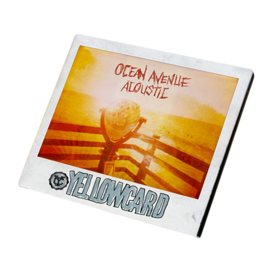A square album cover for Yellowcard’s Acoustic Album shows a sepia sunset with a fence and lifeguard chair. The title Ocean Avenue Acoustic appears at the top, above Yellowcard’s bold white name at the bottom.