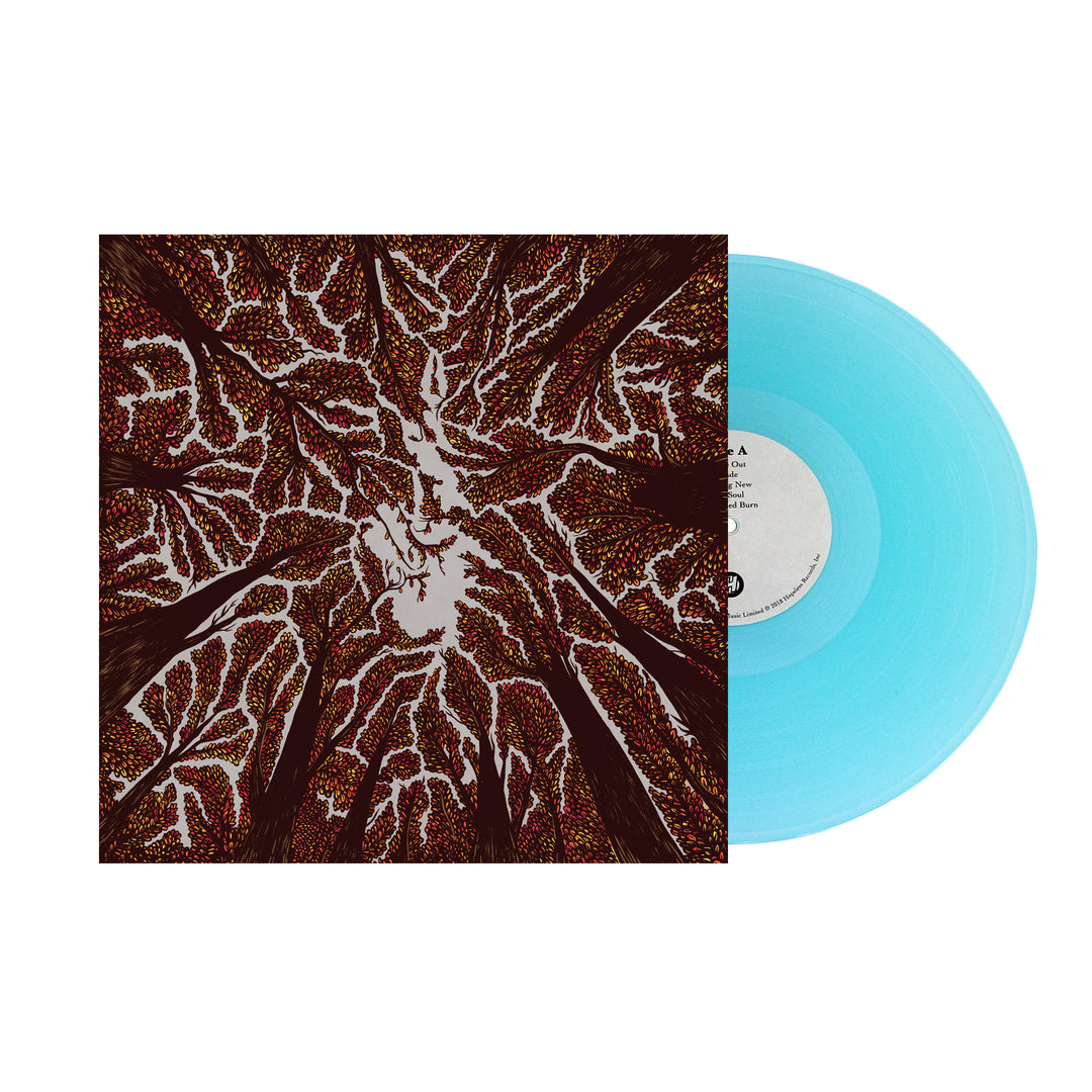 A light blue vinyl record by Trash Boat slides from an album cover with an abstract, top-down view of tall brown trees and colorful dots against a white background, evoking Crown Shyness.