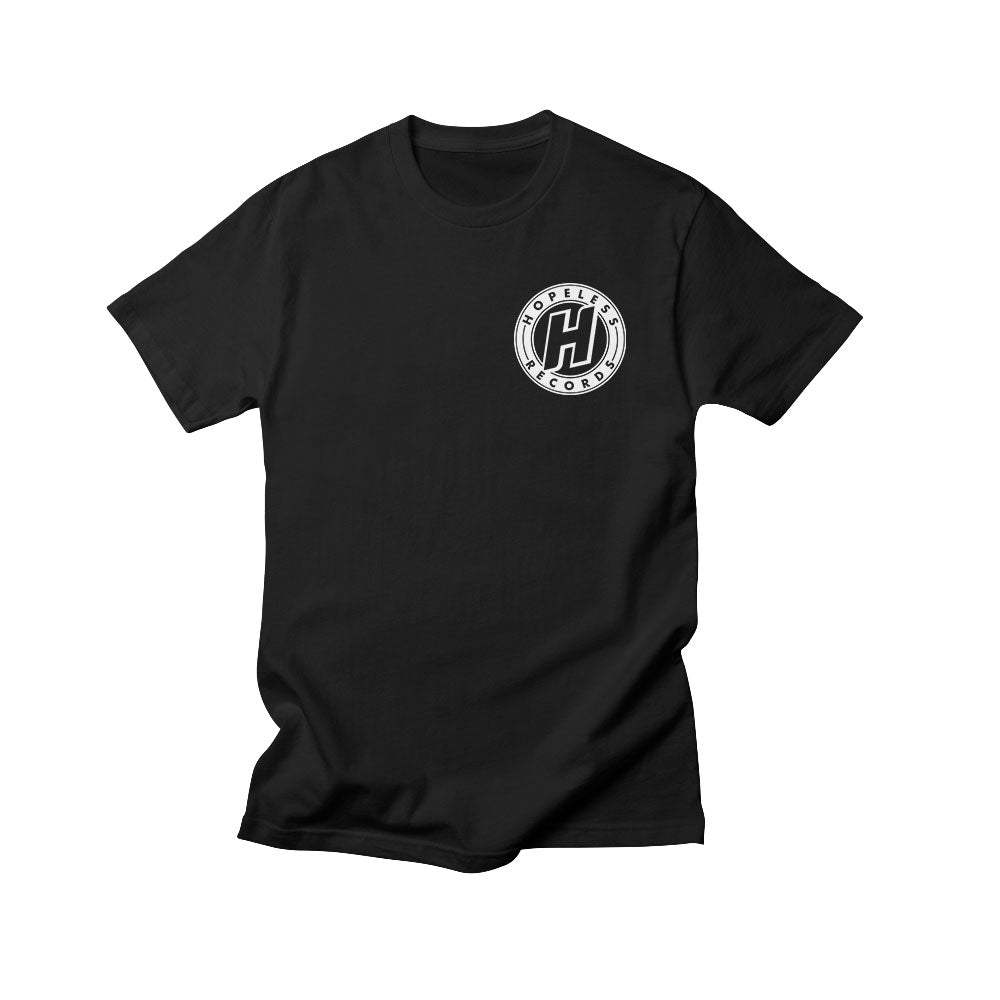 Black t-shirt by Hopeless Records featuring a small white circular black logo with a large "H" and "Hopele Corp" on the left chest, shown on a plain white background.
