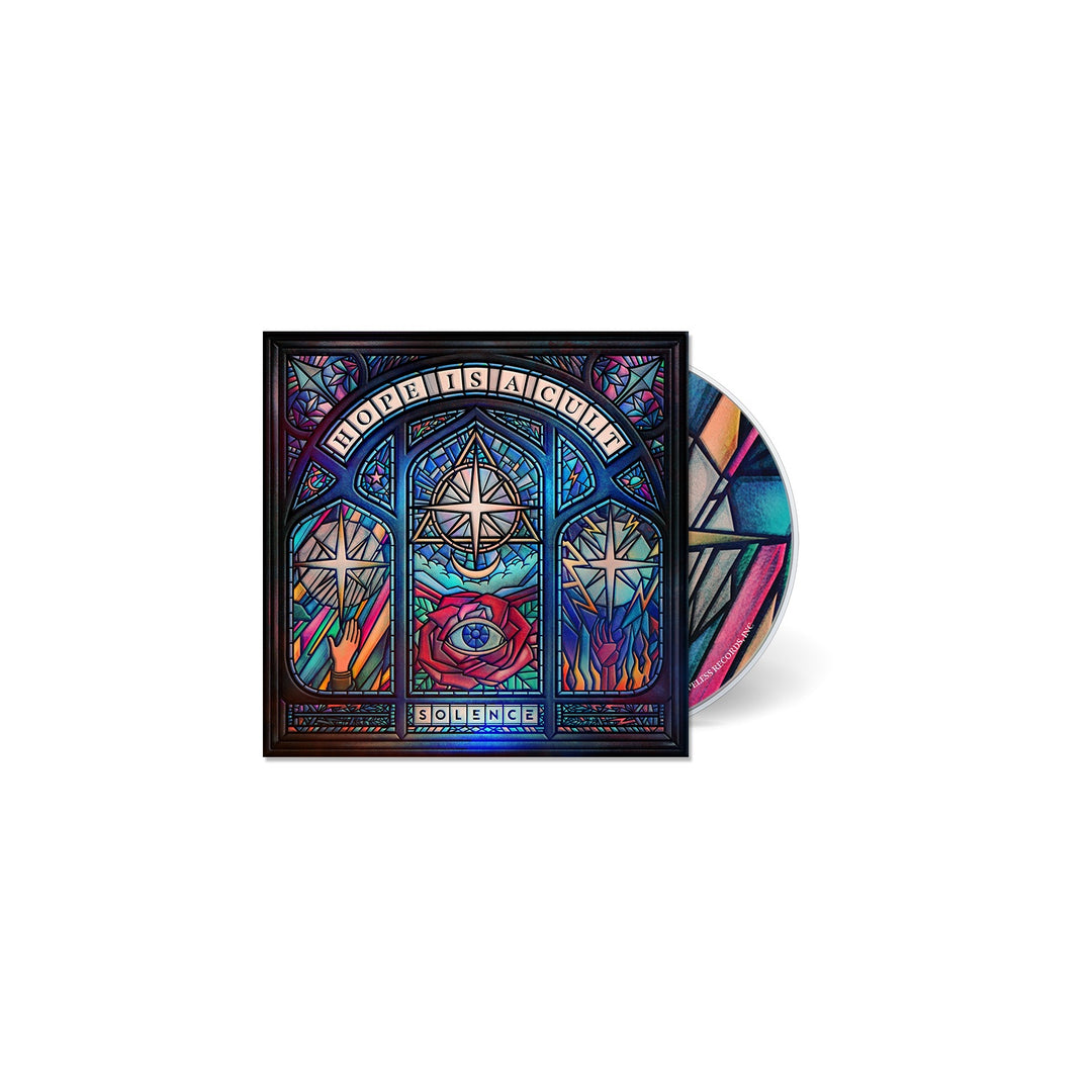 A Solence CD case and disc featuring stained glass window-inspired artwork with a rose, candles, and geometric patterns. HOPE IS A CURE appears at the top, inspired by the Hope Is A Cult CD tracklisting.