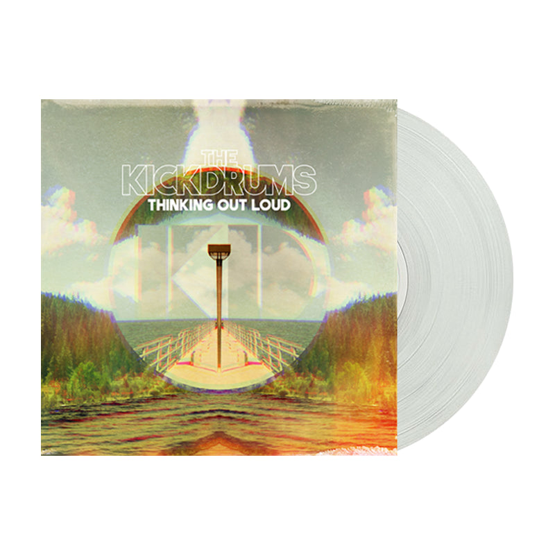 A clear 12 vinyl by The KickDrums partially out of its sleeve, with a lakeside dock cover showing a lamp post, trees, clouds, and “THE KICKDRUMS - THINKING OUT LOUD” in white. Comes with an album download card for easy listening.