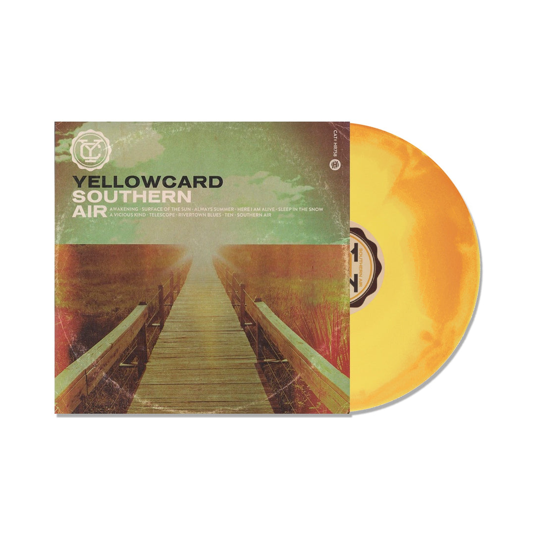 A yellow LP slides out of its cover, which features a wooden bridge into a misty green landscape. The album reads Yellowcard Southern Air with track listings below. Brand: Yellowcard.