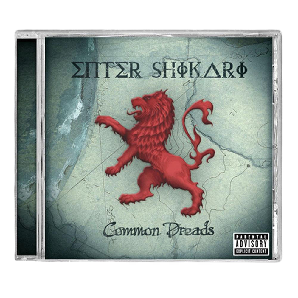 CD cover for Enter Shikaris Common Dreads album, showing a red lion on its hind legs before a faded map, with the band name in stylized text and a parental advisory label—includes standout tracks Solidarity and Juggernauts.
