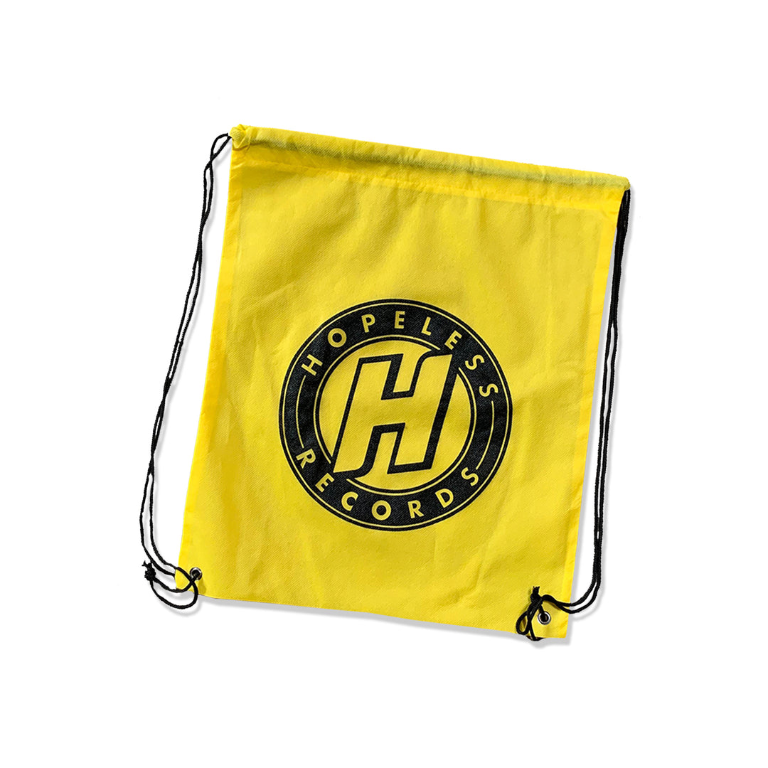 A vibrant yellow drawstring bag from Hopeless Records featuring their black circular logo with an H in the center and Hopeless Records written around it, plus sturdy black drawstrings.