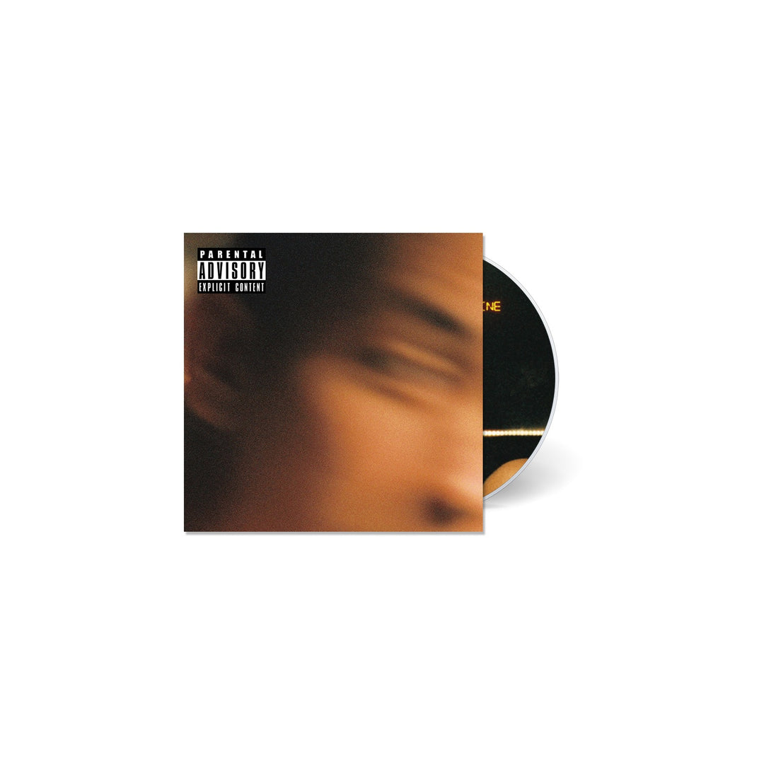 A CD case with a Parental Advisory label displays a blurred face image. Behind it, the Suicide and Sunshine CD by Trophy Eyes peeks out, hinting at the bold tracks from the band.