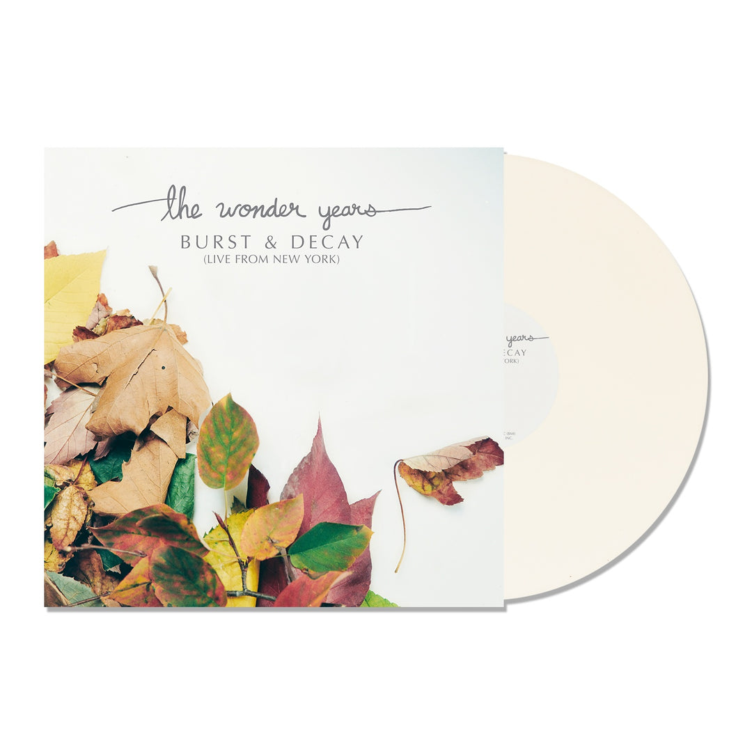 A cream vinyl record slides from an album cover with autumn leaves on white. Tracklist includes Passing Through A Screen Door from The Wonder Years BURST & DECAY (LIVE FROM NEW YORK) in handwritten text.