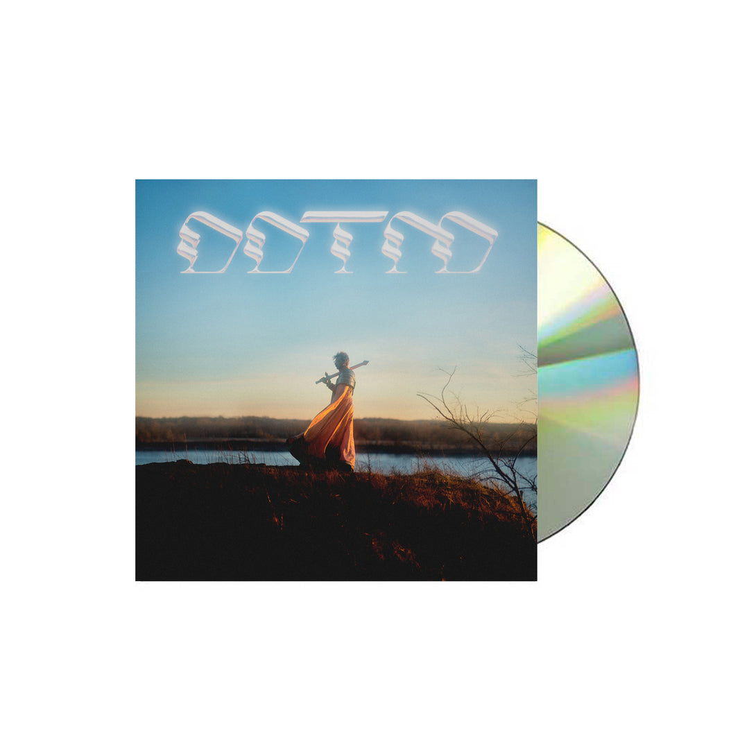 Foxing "Draw Down The Moon" CD Album cover. DDTM letters above a man walking with a sword on a plain with mountains in the background. 