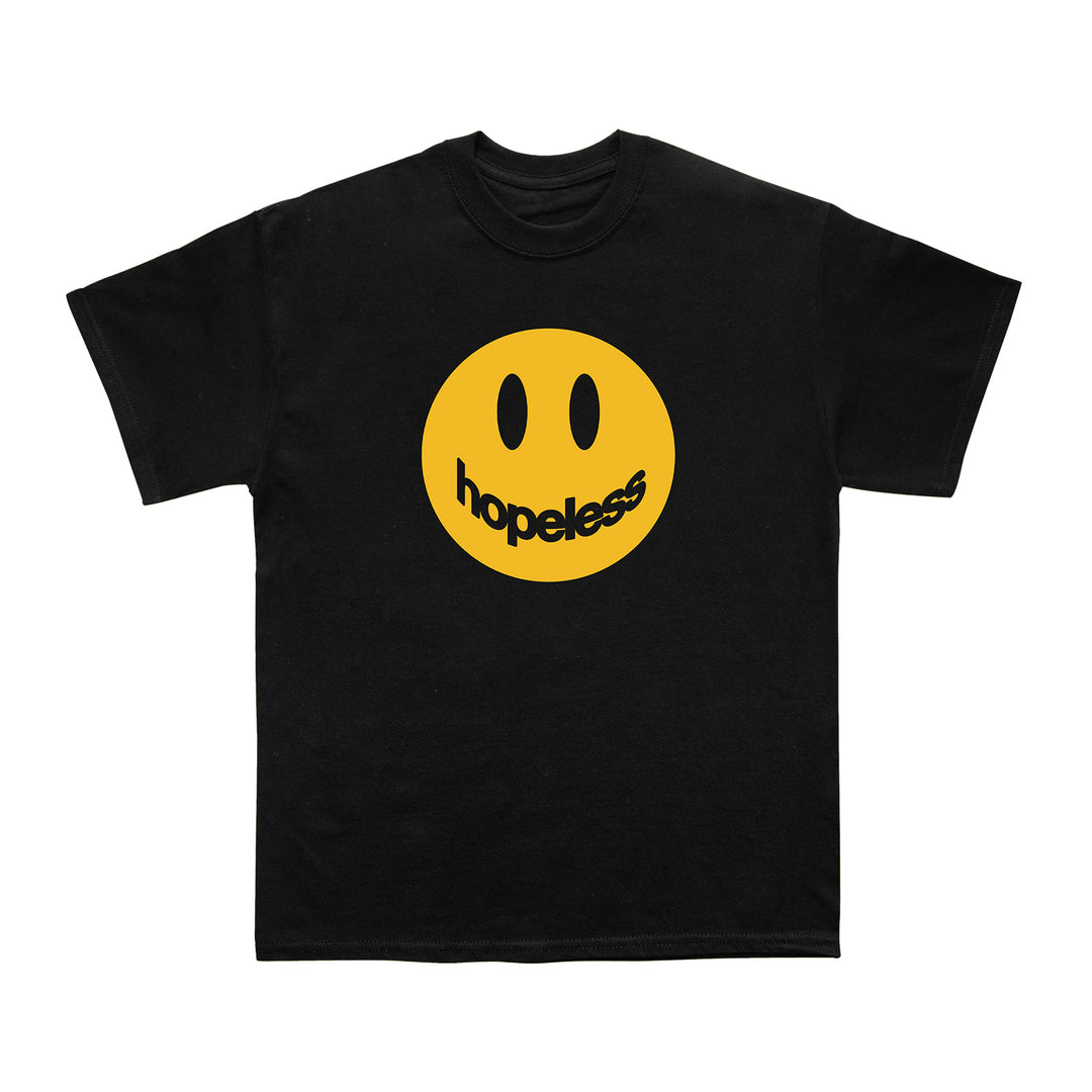 Black T-shirt by Hopeless Records, made from 100% cotton, with a large yellow smiley face on the front; its smile is formed by the word hopeless in warped black text for a standout Hopeless House Design.