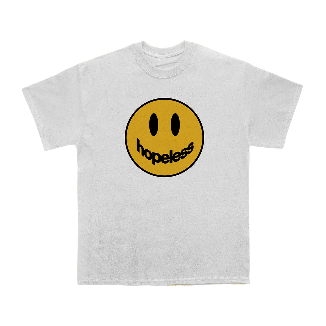 A white 100% cotton Comfort Colors T-shirt by Hopeless Records features a large yellow smiley face with black eyes; hopeless in lowercase black letters forms the mouth—a unique Hopeless House Design.
