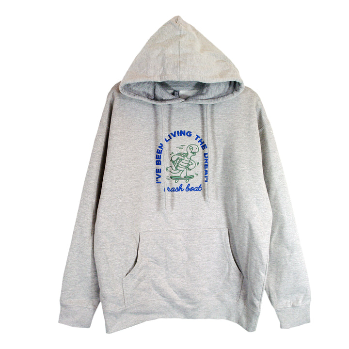 A light gray Trash Boat hoodie with a front pocket, featuring a cartoon frog rowing a boat. “I’VE BEEN LIVING THE BREAK” appears above the image and “break boat” is written below in blue and green letters.