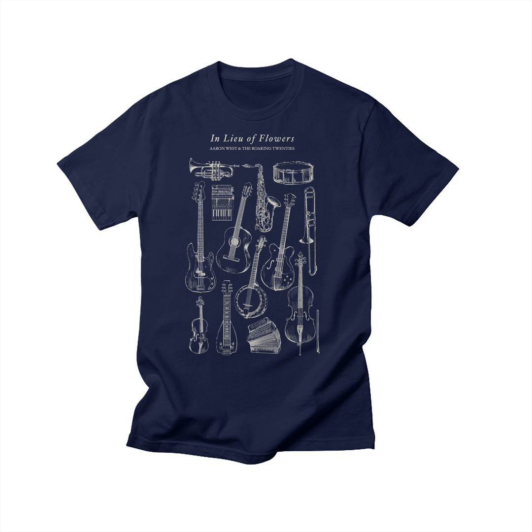 Navy blue T-shirt by Aaron West and the Roaring Twenties featuring exclusive white line illustrations of musical instruments and the text In Lieu Of Flowers and Other Worthy Headstone Twiddles above the artwork.