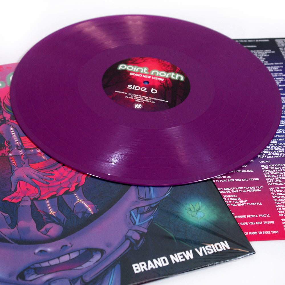 A translucent purple vinyl record by Point North, labeled Brand New Vision, rests on its illustrated album cover featuring vibrant alternative rock artwork and the album’s title. Partial song lyrics are visible nearby.