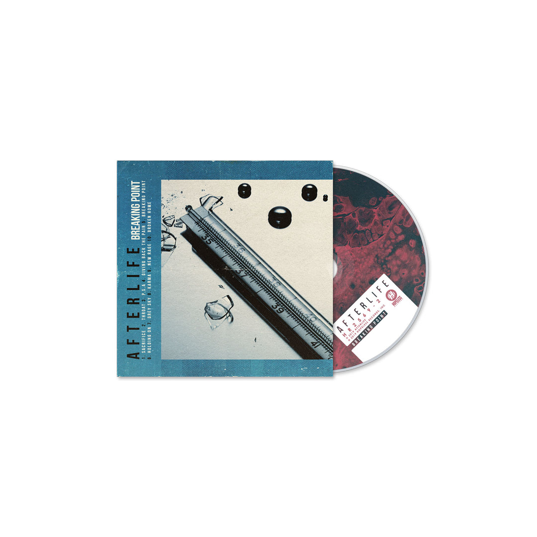 A CD partially in its case titled AFTERLIFE: BREAKING POINT by Afterlife features a cover with scattered pills, a syringe, and a thermometer, evoking addiction themes. The CD and tracklist showcase similar bold design elements.