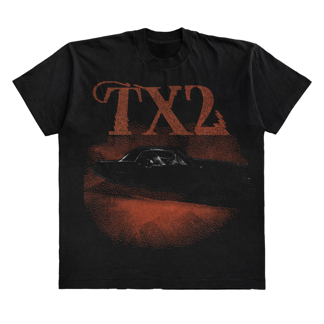 TX2 Black T-shirt with bold, distressed red TX2 letters above a dark car silhouette and textured red circle on the front. Exclusive design by NextLevel.