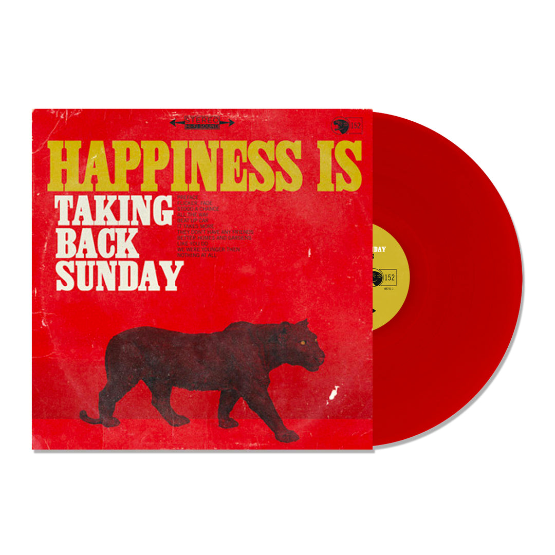 A transparent red vinyl record slides out of its sleeve. The red cover, featuring yellow and white text and a black walking panther silhouette, displays Happiness Is by Taking Back Sunday.