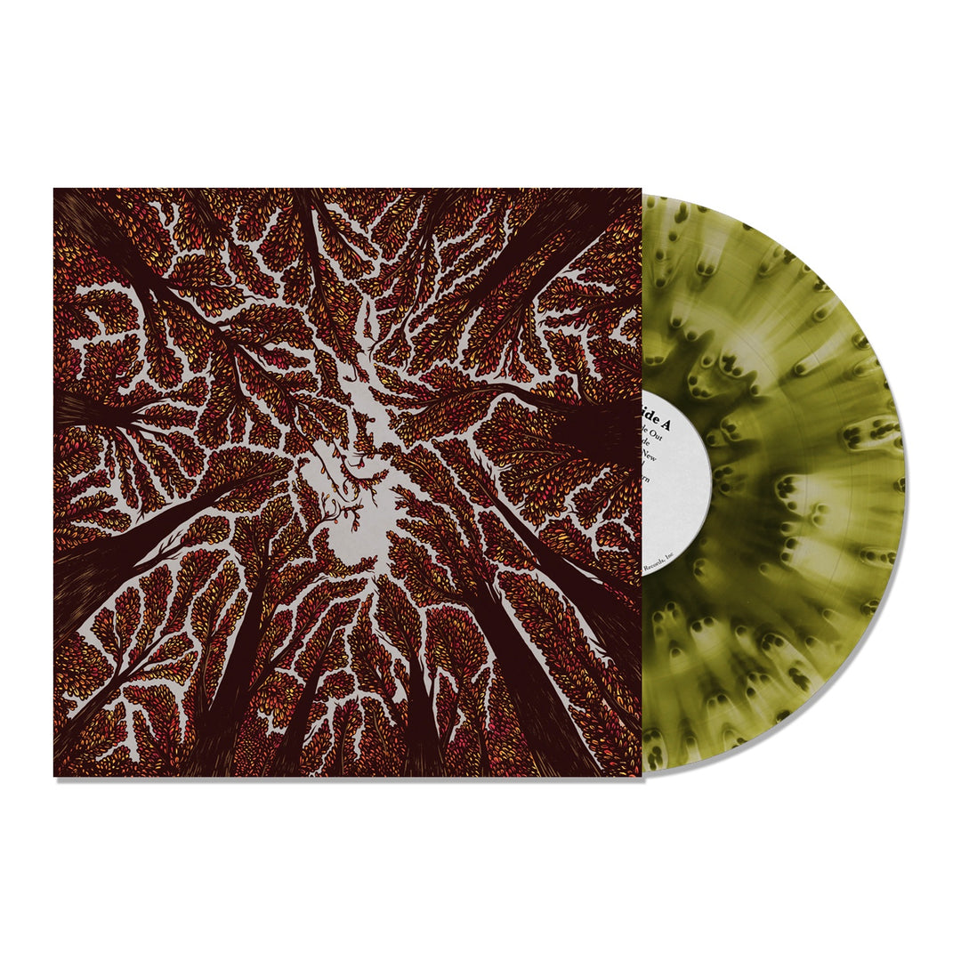 A marbled Cloudy Green LP partially slides from its sleeve, which is decorated with abstract tree-branch designs in dark red, brown, and white—a striking tribute to Crown Shyness by Trash Boat.