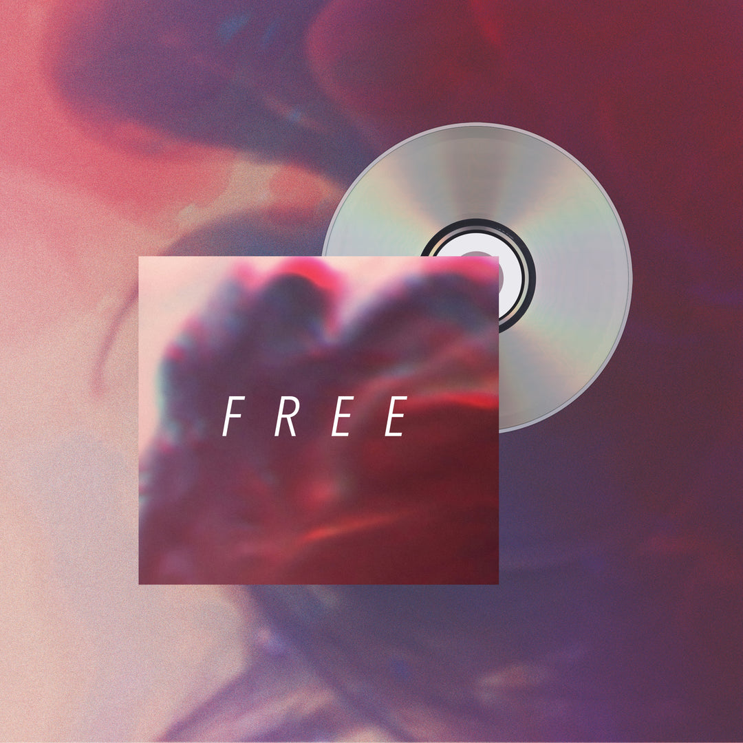 A Hundredth Free CD is partly hidden behind an album cover with a red-blue blurred abstract background. "FREE" appears in bold white letters, echoing the album's colors and hinting at its tracklist. Brand: Hundredth.