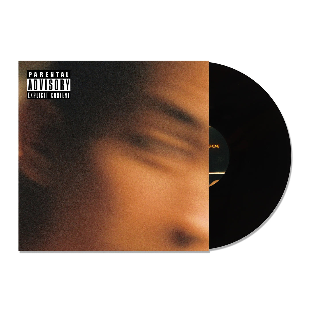 A Black Vinyl record partially slides out of its sleeve, which displays a blurred close-up of a face, the Trophy Eyes Suicide And Sunshine title, and a Parental Advisory Explicit Content label in the top left corner.