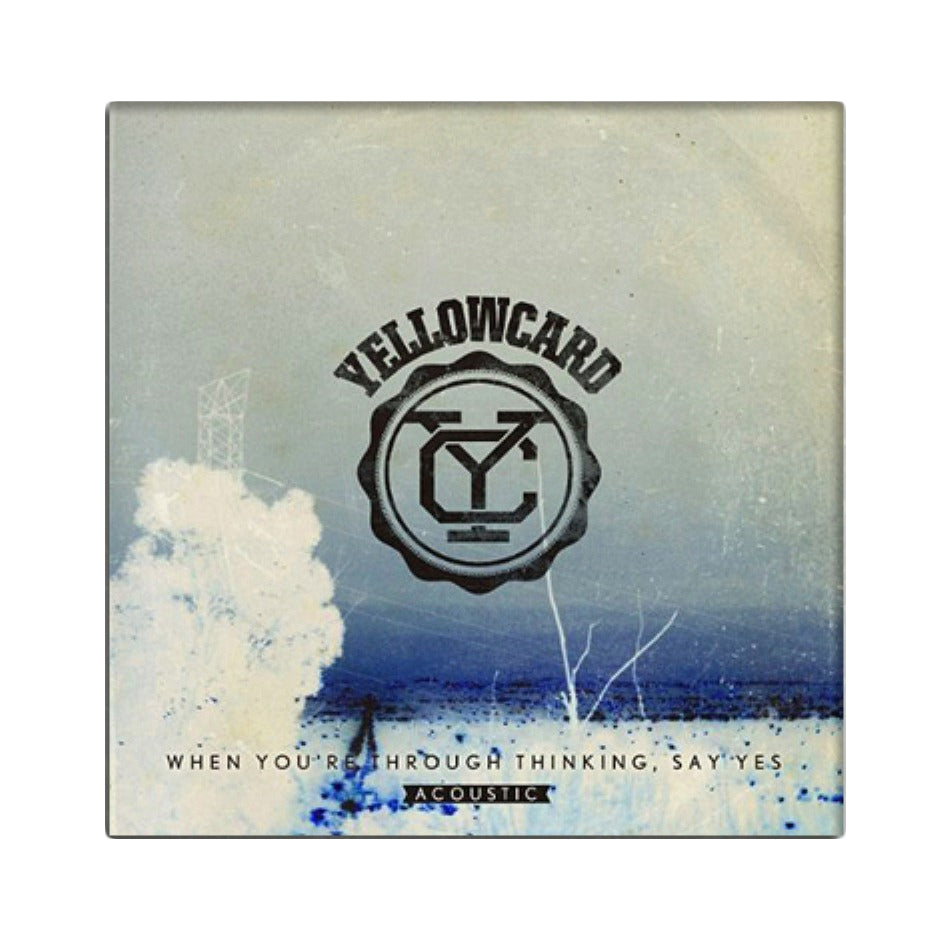 Album cover for Yellowcard’s acoustic CD “When You’re Through Thinking, Say Yes” shows the Yellowcard logo in black on a blue-tinted background with white foliage and abstract outdoor elements.