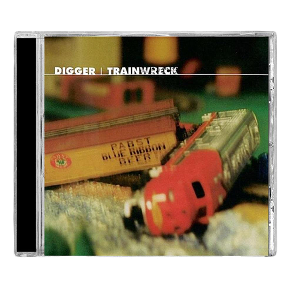 CD cover for Digger’s Trainwreck EP shows a blurred toy train derailment—featuring a yellow Pabst Blue Ribbon boxcar and red locomotive on a model landscape—that visually captures the chaotic energy of the music.