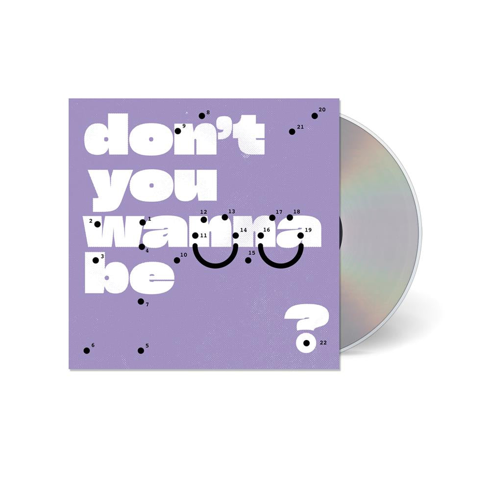 A CD partially out of its lavender case, displaying large white text dont you wanna be? with black dots and numbers forming a dot-to-dot smiley face—Super Whatevr’s artwork inviting you to feel better.