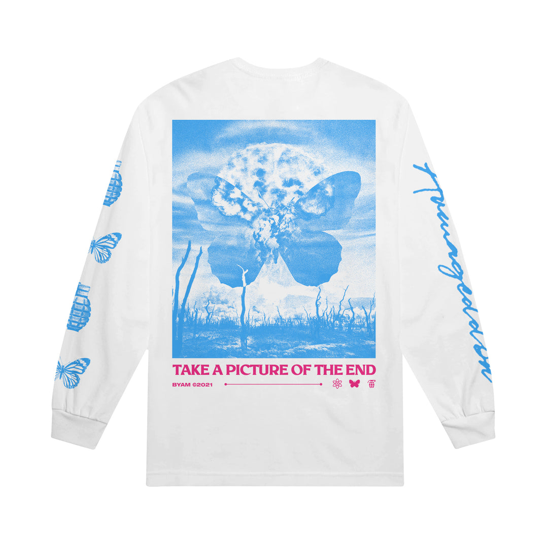 The Between You And Me Armageddon Long Sleeve features a white base with blue butterflies, clouds, and dried plants graphics. "TAKE A PICTURE OF THE END" decorates the back, with blue butterfly accents on the sleeves.