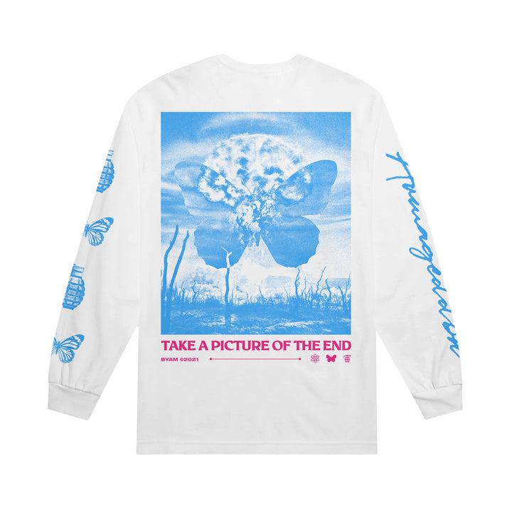 The Between You And Me Armageddon Long Sleeve features a white base with blue butterflies, clouds, and dried plants graphics. "TAKE A PICTURE OF THE END" decorates the back, with blue butterfly accents on the sleeves.