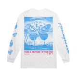 The Between You And Me Armageddon Long Sleeve features a white base with blue butterflies, clouds, and dried plants graphics. "TAKE A PICTURE OF THE END" decorates the back, with blue butterfly accents on the sleeves.