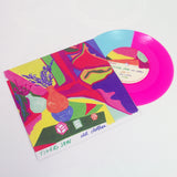 A blue and neon magenta vinyl record by Tigers Jaw partially slides out of a colorful album cover with abstract shapes, vases, dice, and handwritten tracklisting. The cover reads old clothes in handwritten text.